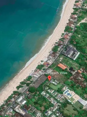 an aerial view of a beach with a red marker at Sunset Palms Beach Villa in Jimbaran
