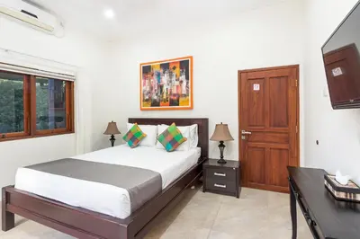 a bedroom with a bed and a wooden door at Villa Yati in Seminyak