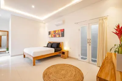 a bedroom with a bed and a view of the ocean at Amazing Villa in Oberoi Top Location in Seminyak