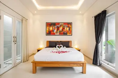 a bedroom with a bed with a white bedspread at Amazing Villa in Oberoi Top Location in Seminyak