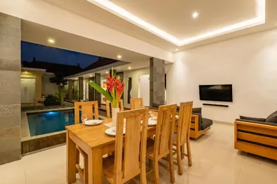 a dining room with a wooden table and chairs at Amazing Villa in Oberoi Top Location in Seminyak