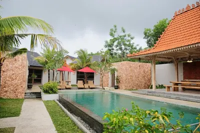 a swimming pool in the backyard of a house at Vivara Bali Private Pool Villas & Spa Retreat in Jimbaran