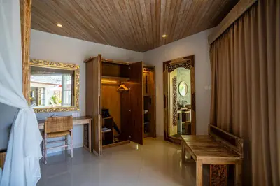 a living room with a bench and a mirror at Vivara Bali Private Pool Villas & Spa Retreat in Jimbaran