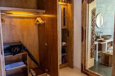 a room with a wooden door and a mirror at Vivara Bali Private Pool Villas & Spa Retreat in Jimbaran