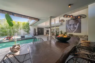 a dining room with a table with a bowl of fruit on it at Villa Wiraja 1 - Modern 4 bdr villa in Berawa in Canggu
