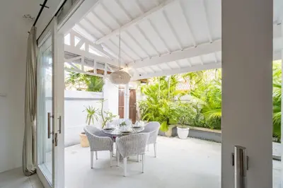 a dining room with a table and chairs at Villa Margaretta in Seminyak