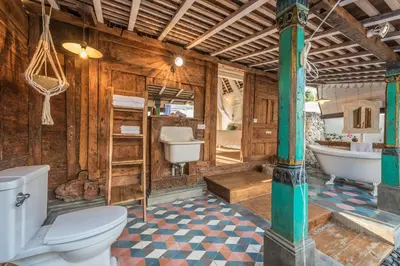 a bathroom with a toilet and a tub and a sink at Sol Lila Bali in Canggu