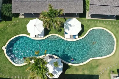 an overhead view of a swimming pool with umbrellas at Sol Lila Bali in Canggu