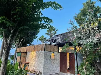 a house with a balcony on top of it at Modern Balinese Villa with Scenic View in Nusa Dua