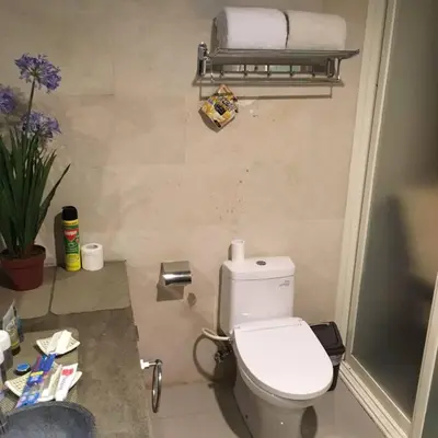 a small bathroom with a toilet and a sink at Modern Balinese Villa with Scenic View in Nusa Dua