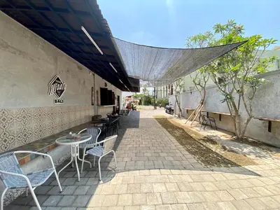 a patio with tables and chairs on a sidewalk at Timaya Villa BEST LOCATION in Legian
