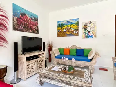 a living room with a couch and a tv at Timaya Villa BEST LOCATION in Legian