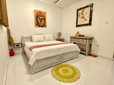 a bedroom with a bed and a table at Timaya Villa BEST LOCATION in Legian