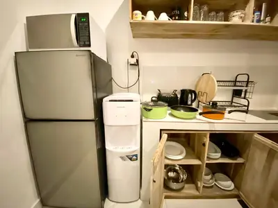 a small kitchen with a refrigerator and a counter at Timaya Villa BEST LOCATION in Legian