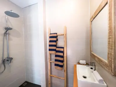 a bathroom with a sink and a mirror at Puspa Ayu Villas & Apartments in Kuta