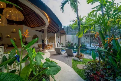 a backyard with a pool and some plants at Lamoon Villas Berawa in Canggu