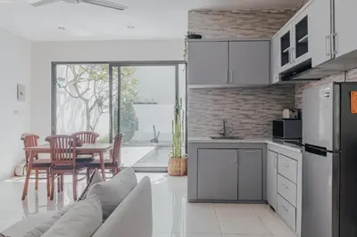 a kitchen with a couch and a table with chairs at Cozy 2BR Private Pool Villa, Oberoi, Central Seminyak, Bali in Seminyak