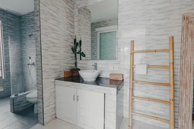 a bathroom with a sink and a toilet and a mirror at Cozy 2BR Private Pool Villa, Oberoi, Central Seminyak, Bali in Seminyak