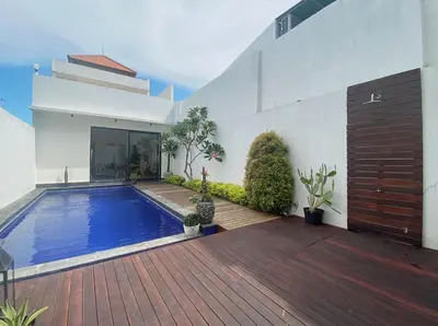 a swimming pool in the backyard of a house at Cozy 2BR Private Pool Villa, Oberoi, Central Seminyak, Bali in Seminyak