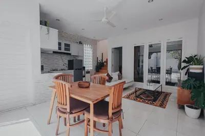 a kitchen and dining room with a wooden table and chairs at Cozy 2BR Private Pool Villa, Oberoi, Central Seminyak, Bali in Seminyak