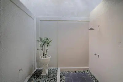 a bathroom with a plant in a pot on the floor at Villa Noni Seminyak in Seminyak