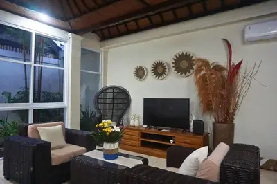 a living room with a flat screen tv and furniture at Villa Noni Seminyak in Seminyak
