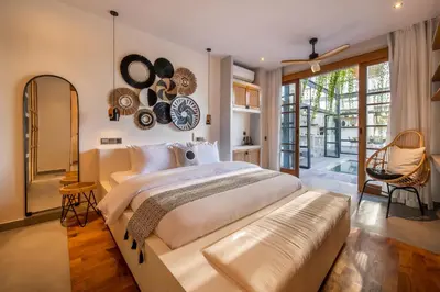 a bedroom with a large bed with a large clock on the wall at Villa Yukiko Canggu in Canggu