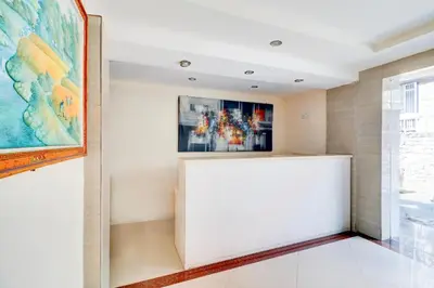 a room with a painting on the wall next to a window at Collection O Near Bajra Sandi Monumen Formerly Grand Pondok Puri Ayu in Denpasar