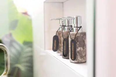 a row of toothbrushes on a shelf in a bathroom at Villa Sintra - 2 BR luxury in tranquil location, walk to beach in Seminyak