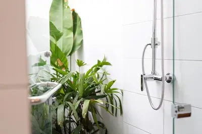 a bathroom with a shower with plants in it at Casa Sintra - Romantic, tranquil hideaway, walk to beach in Seminyak