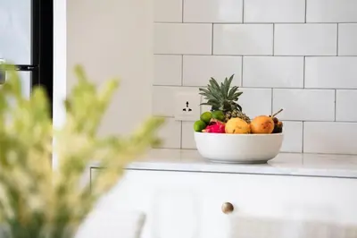 a bowl of fruit on a counter in a kitchen at Casa Sintra - Romantic, tranquil hideaway, walk to beach in Seminyak