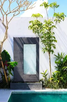 a house with a glass window next to a swimming pool at Casa Sintra - Romantic, tranquil hideaway, walk to beach in Seminyak
