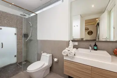 a bathroom with a toilet and a sink and a mirror at Villa Iluka by SooBali in Seminyak