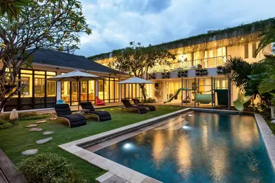 a house with a swimming pool in the yard at Villa Iluka by SooBali in Seminyak