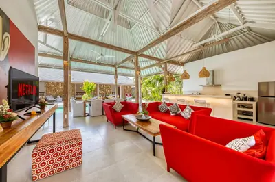 an open living room with red chairs and tables at PROMO 4 bd Spacious villa in strategic location in Seminyak