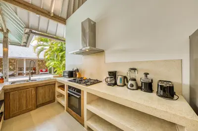 a kitchen with a counter with a stove top oven at PROMO 4 bd Spacious villa in strategic location in Seminyak