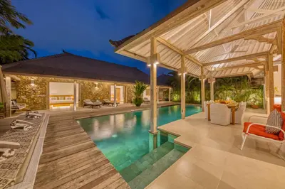 an outdoor living area with a pool and a house at PROMO 4 bd Spacious villa in strategic location in Seminyak