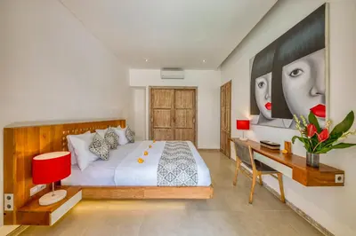 a bedroom with a bed and a desk at PROMO 4 bd Spacious villa in strategic location in Seminyak