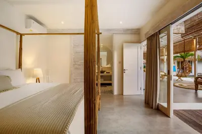 a bedroom with a bed and a view of a room at Villa Surga Blue by Alfred in Bali in Seminyak