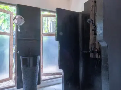 a bathroom with a shower and a window at Ocean Star 1 in Seminyak