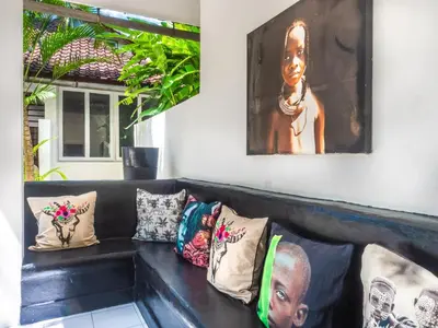 a black couch with a bunch of pillows on it at Ocean Star 1 in Seminyak