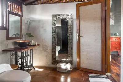 a bathroom with a door and a table and a mirror at Ocean Star Villa Four Bedrooms Seminyak in Seminyak