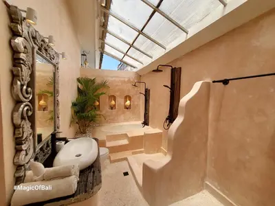 a bathroom with a toilet and a tub and a sink at Ocean Star 3 in Seminyak