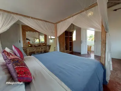 a bedroom with a large bed with a blue blanket at Ocean Star 3 in Seminyak