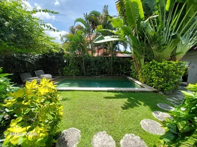 a small pool in the middle of a yard at Ocean Star 3 in Seminyak