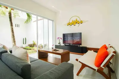 a living room with a couch and a tv at Villa Akmali Seminyak Drupadi 2 Bedrooms w/Pool 5mins to Beach in Seminyak