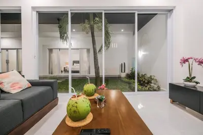 a living room with a couch and a table at Villa Akmali Seminyak Drupadi 2 Bedrooms w/Pool 5mins to Beach in Seminyak