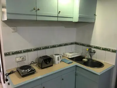 a kitchen counter with a sink and a toaster at Private Apartment inside Beach Resort Jayakarta in Seminyak