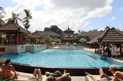 a group of people laying in the pool at a resort at Private Apartment inside Beach Resort Jayakarta in Seminyak