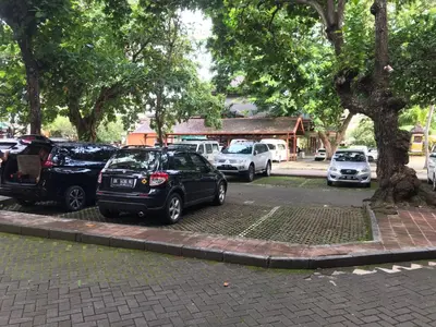 a group of cars parked in a parking lot at Private Apartment inside Beach Resort Jayakarta in Seminyak